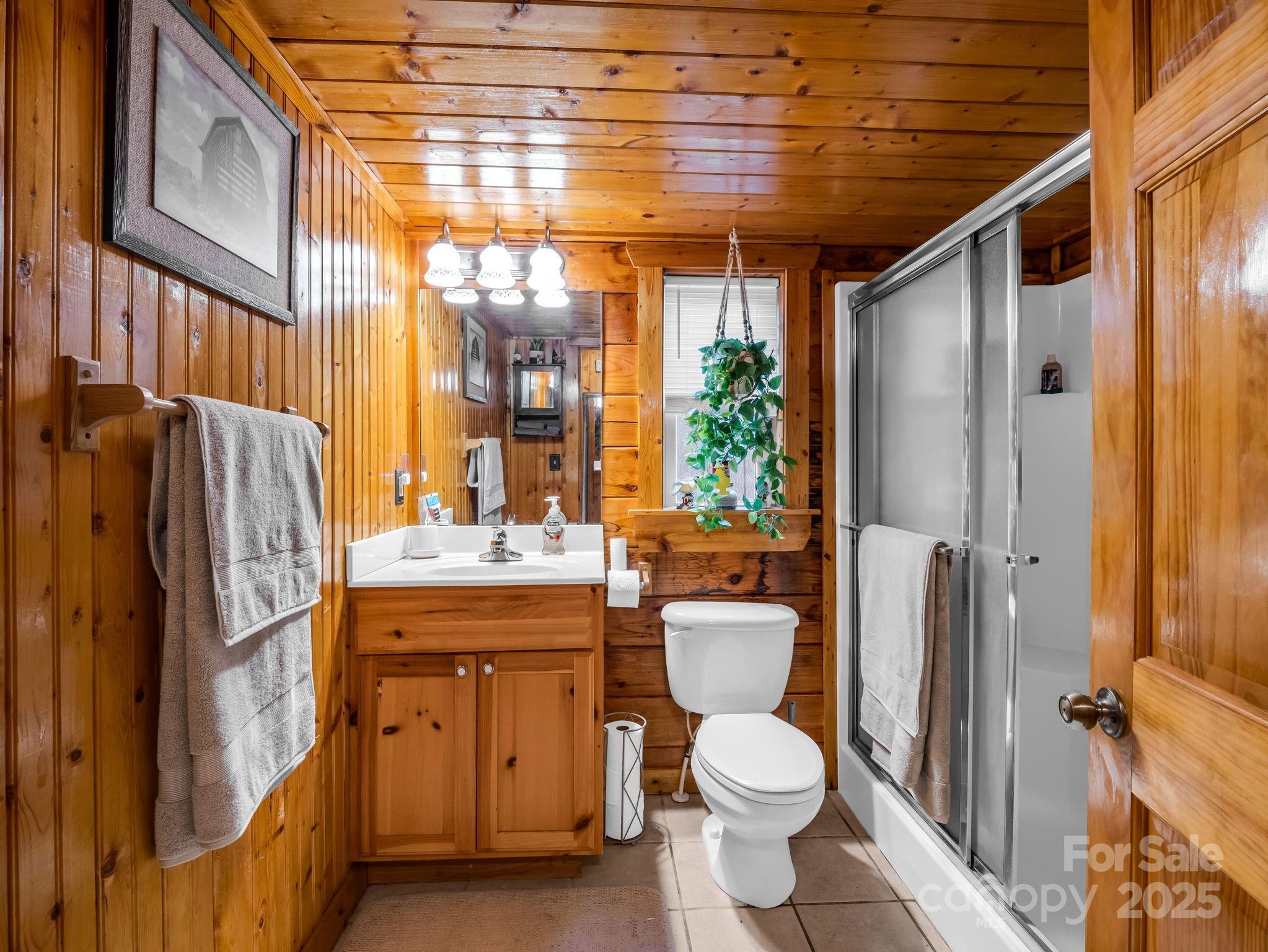 815 Cross Ridge Drive Rutherfordton, NC 28139 - Photo 25 of 34 a bathroom with a granite countertop toilet sink and shower