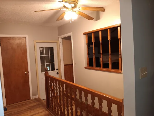 a view of an empty room with wooden floor