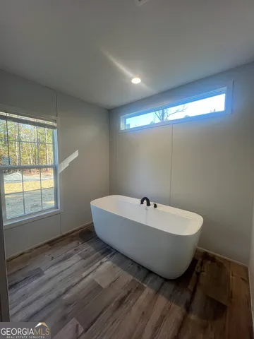 a spacious bathroom with a bathtub and shower