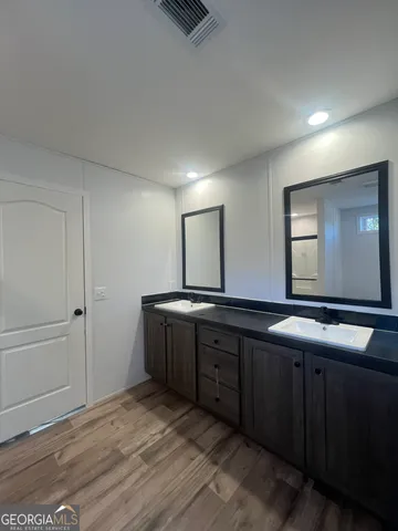 a bathroom with a sink and a large mirror