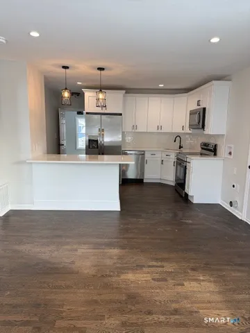 a view of kitchen with wooden floor