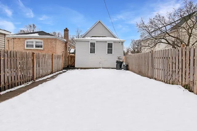 a front view of a house with a wooden fence