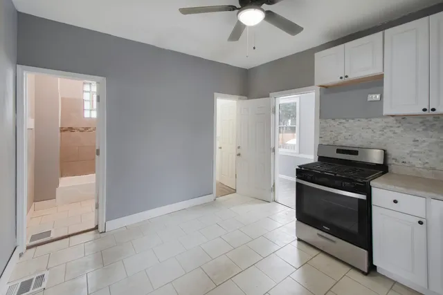 a kitchen with cabinets and stainless steel appliances