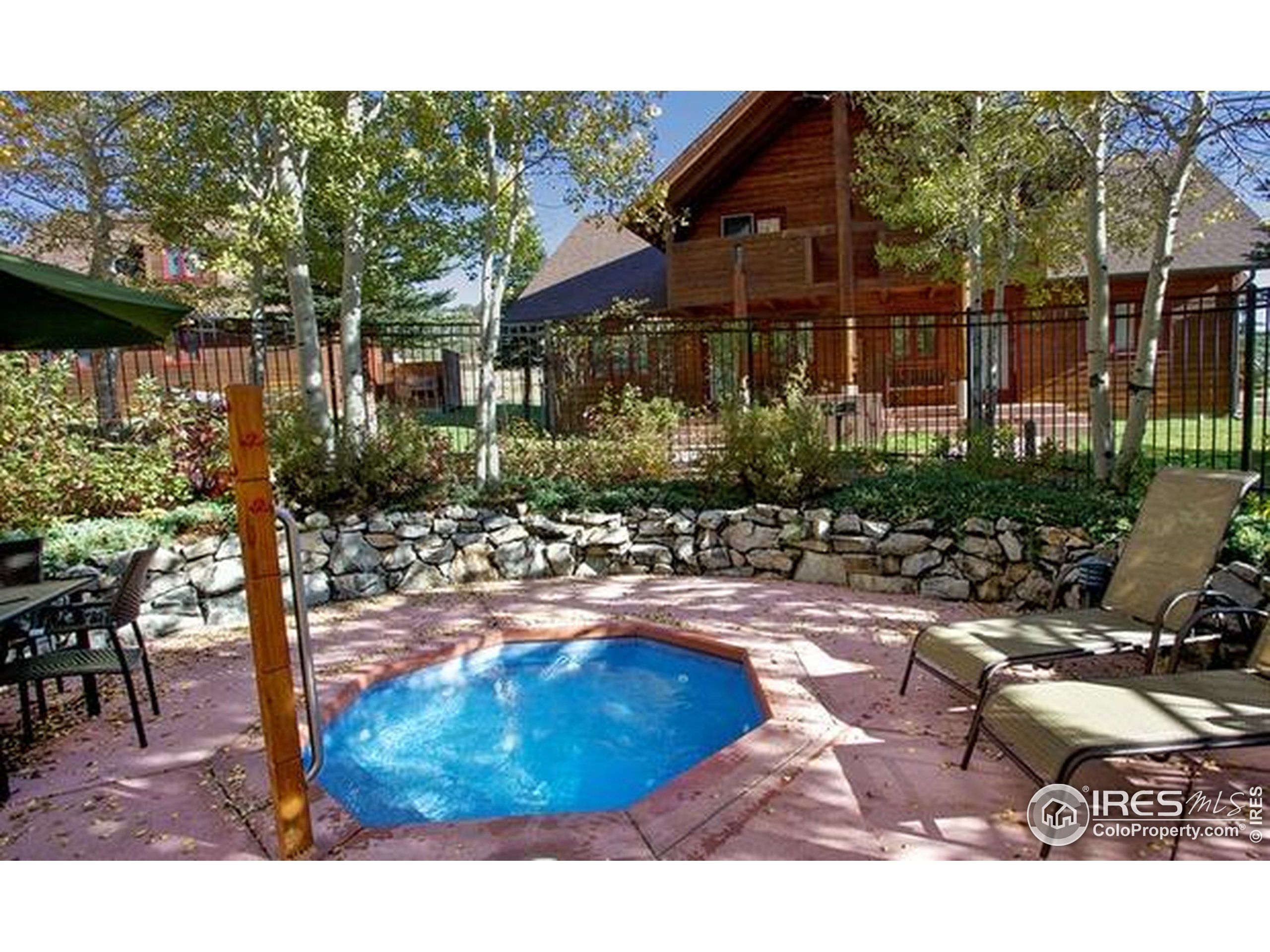 1565 Highway 66, Unit 49 Estes Park, CO 80517 - Photo 12 of 17 a backyard of a house with yard and outdoor seating