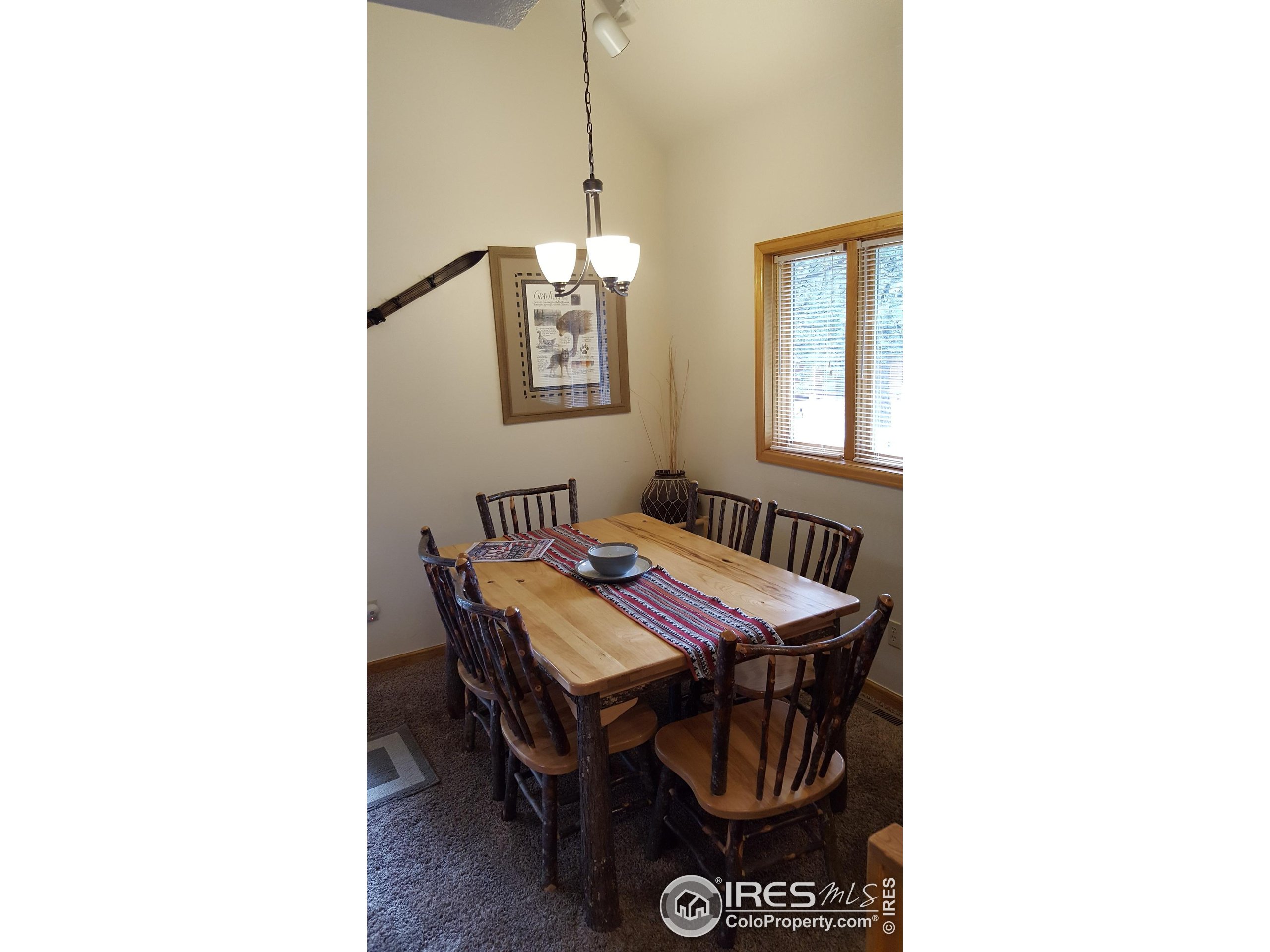 1565 Highway 66, Unit 49 Estes Park, CO 80517 - Photo 15 of 17 a dining room with furniture and window
