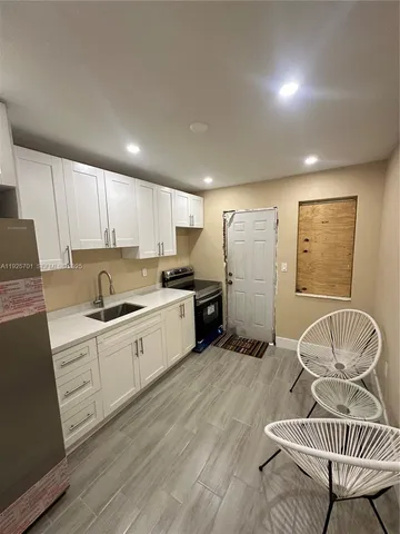 a kitchen with a refrigerator and cabinets