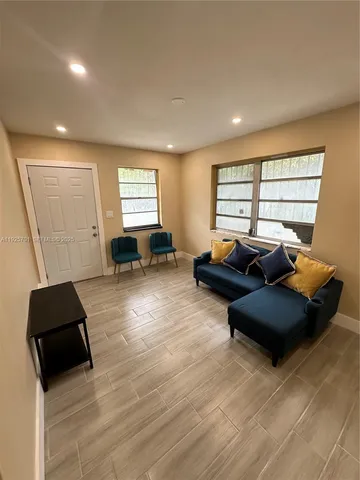 a living room with furniture and a window