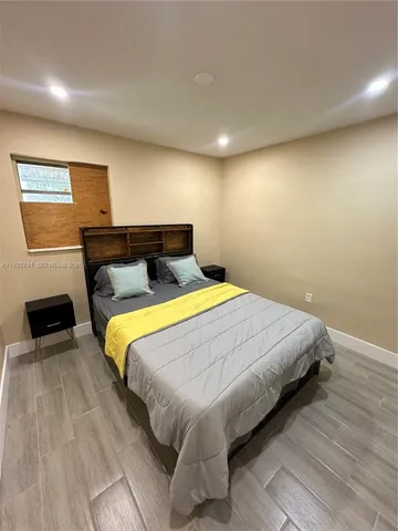 a bedroom with a bed and a television