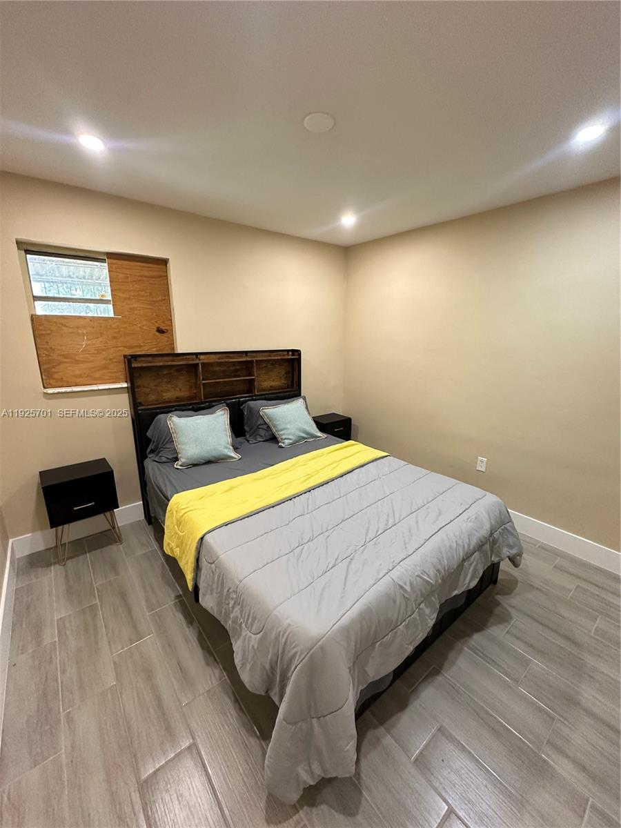 234 Northeast 55th Terrace Miami, FL 33137 - Photo 20 of 22 a bedroom with a bed and a television