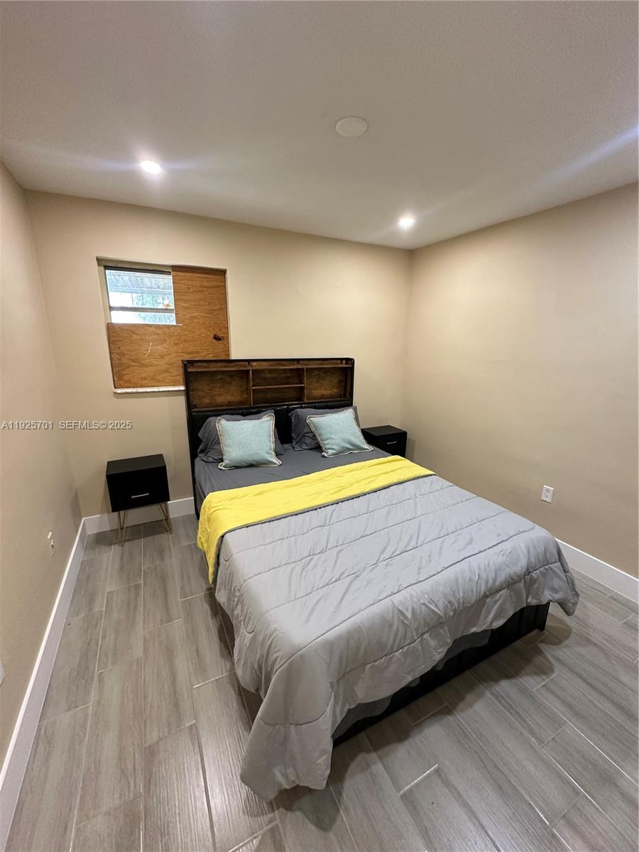 234 Northeast 55th Terrace Miami, FL 33137 - Photo 21 of 22 a bed sitting in a spacious bedroom next to a window