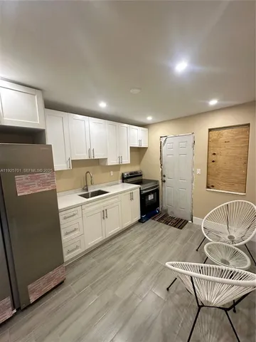 a kitchen with stainless steel appliances granite countertop a refrigerator sink and cabinets