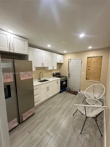 a kitchen with stainless steel appliances granite countertop a refrigerator sink and cabinets