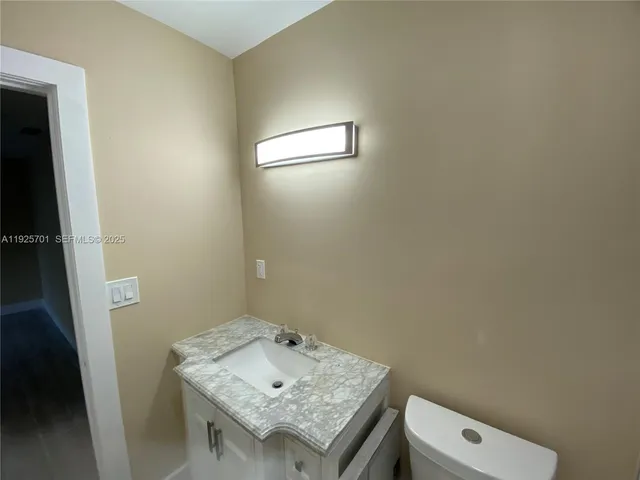 a bathroom with a sink toilet and mirror