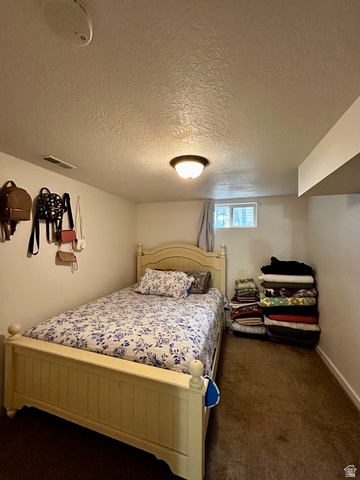 1931 Harrison Boulevard Ogden, UT 84401 - Photo 10 of 21 Bedroom #3 Carpeted room featuring a single window, white walls, and a flush-mount ceiling light fixture