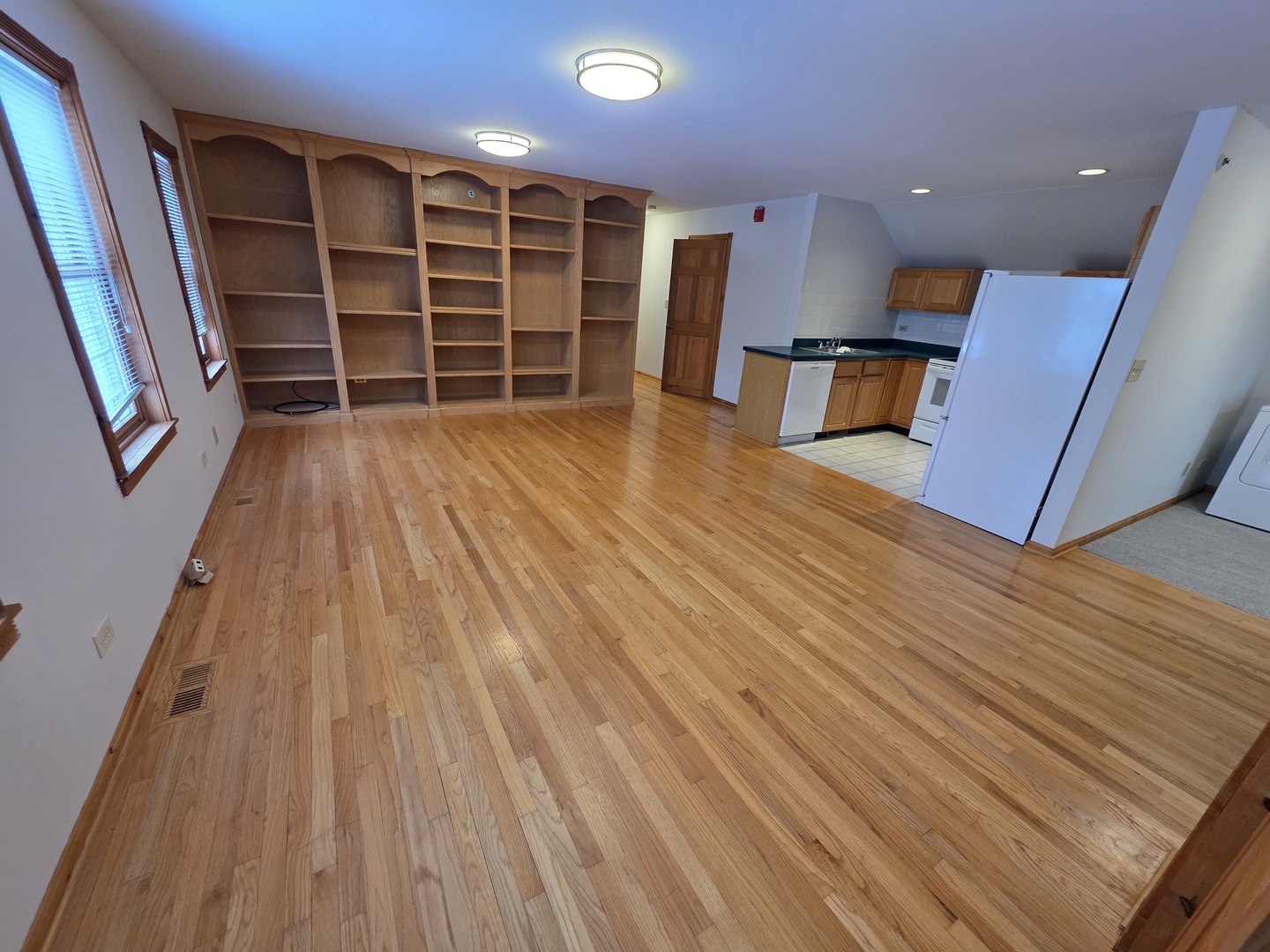 236 Robert Parker Coffin Road, Unit 236 Long Grove, IL 60047 - Photo 3 of 8 a view of an empty room with wooden floor and a window