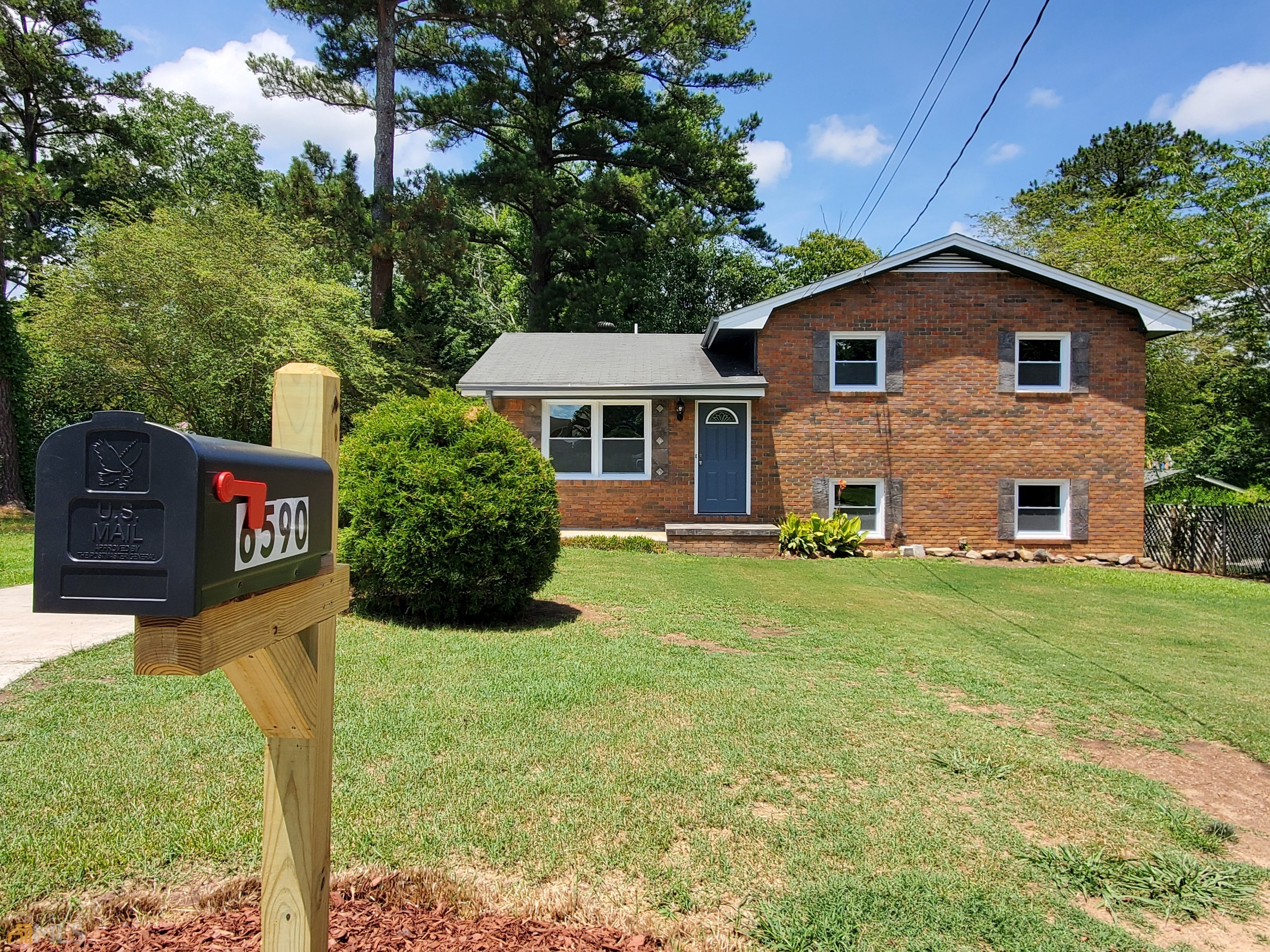 6590 Allatoona Road Morrow, GA 30260 - Photo 1 of 1 a front view of a house with garden