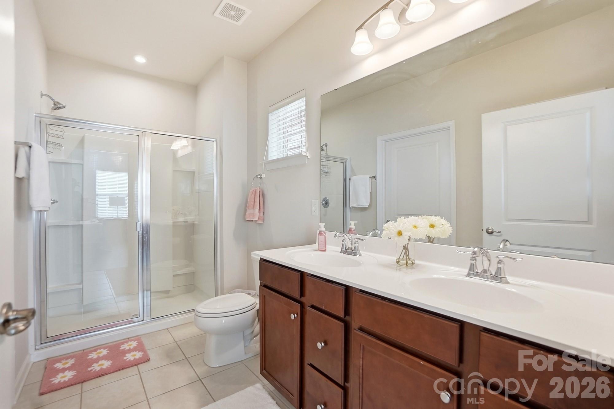 1842 Slippery Rock Lane Monroe, NC 28112 - Photo 15 of 25 a bathroom with a sink a toilet and shower