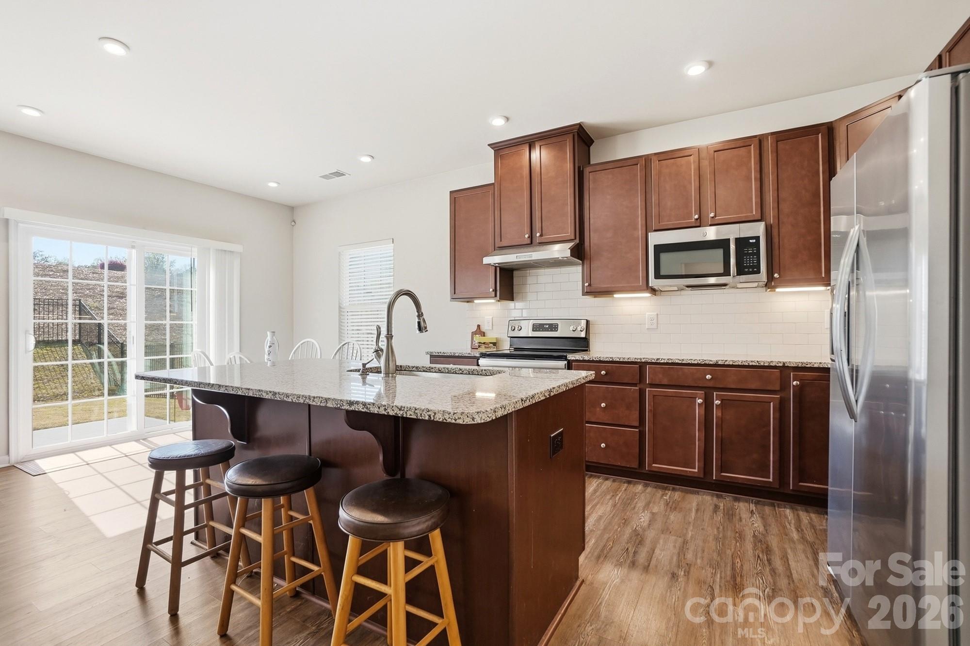 1842 Slippery Rock Lane Monroe, NC 28112 - Photo 4 of 25 a kitchen with a sink stove and refrigerator