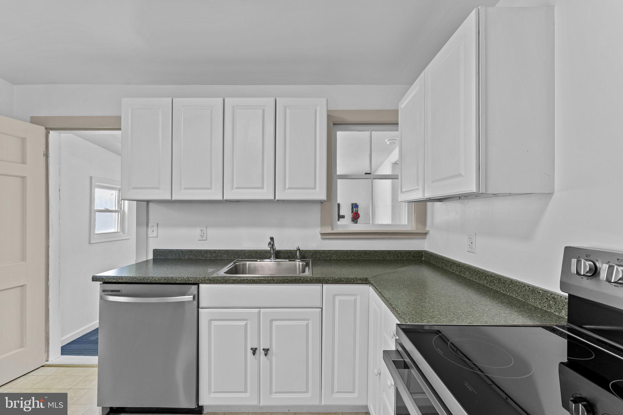 216 Walnut Street Berryville, VA 22611 - Photo 28 of 36 a kitchen with stainless steel appliances granite countertop a sink stove and cabinets