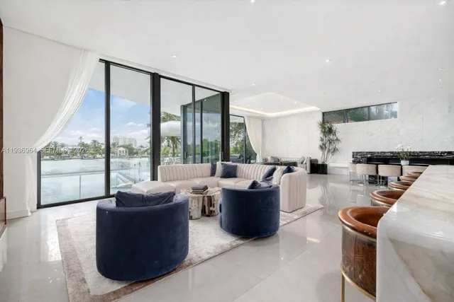 a view of a terrace with furniture and a garden