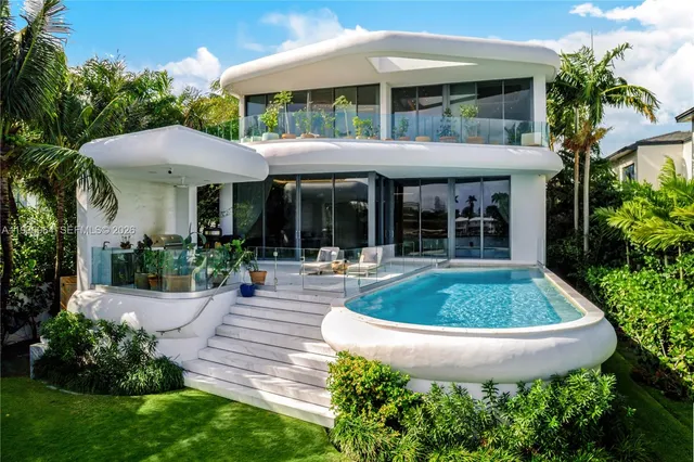 a front view of a house with a garden and patio