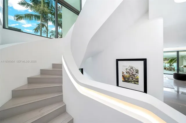 a living room with large window and a wooden floor