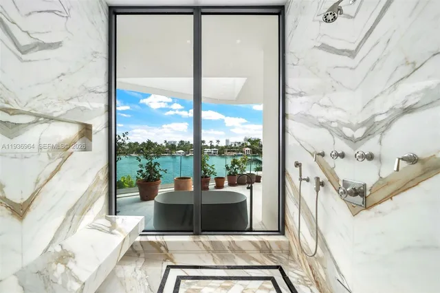 a bedroom with a large bed and a flat tv screen on dresser