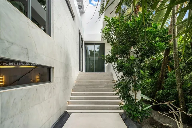 a living room with furniture and floor to ceiling windows