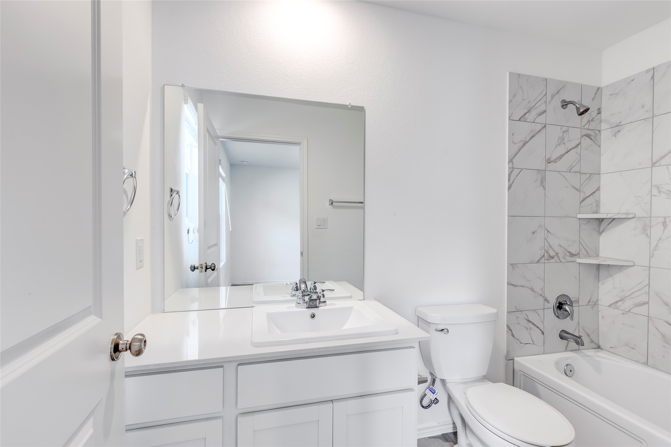 591 Avre Loop Kyle, TX 78640 - Photo 25 of 34 a bathroom with a sink toilet vanity and shower