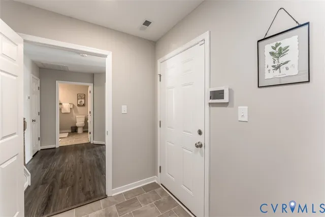 a view of a livingroom with wooden floor and a livingroom