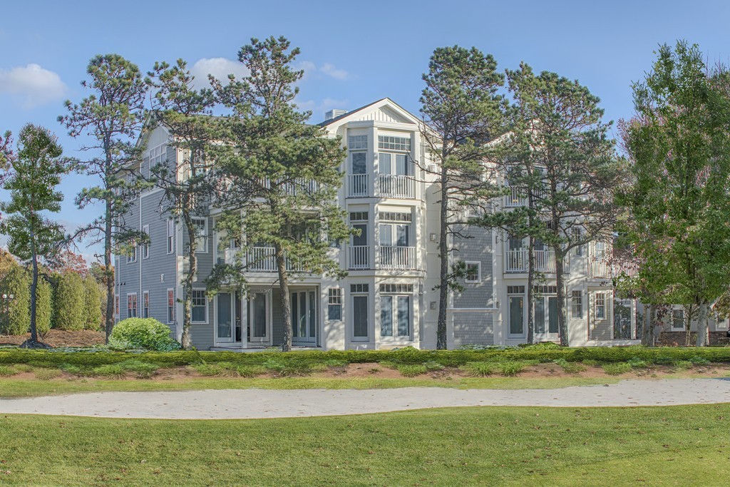 64 Simons Road, Unit C Mashpee, MA 02649 - Photo 1 of 9 a front view of a house with a yard