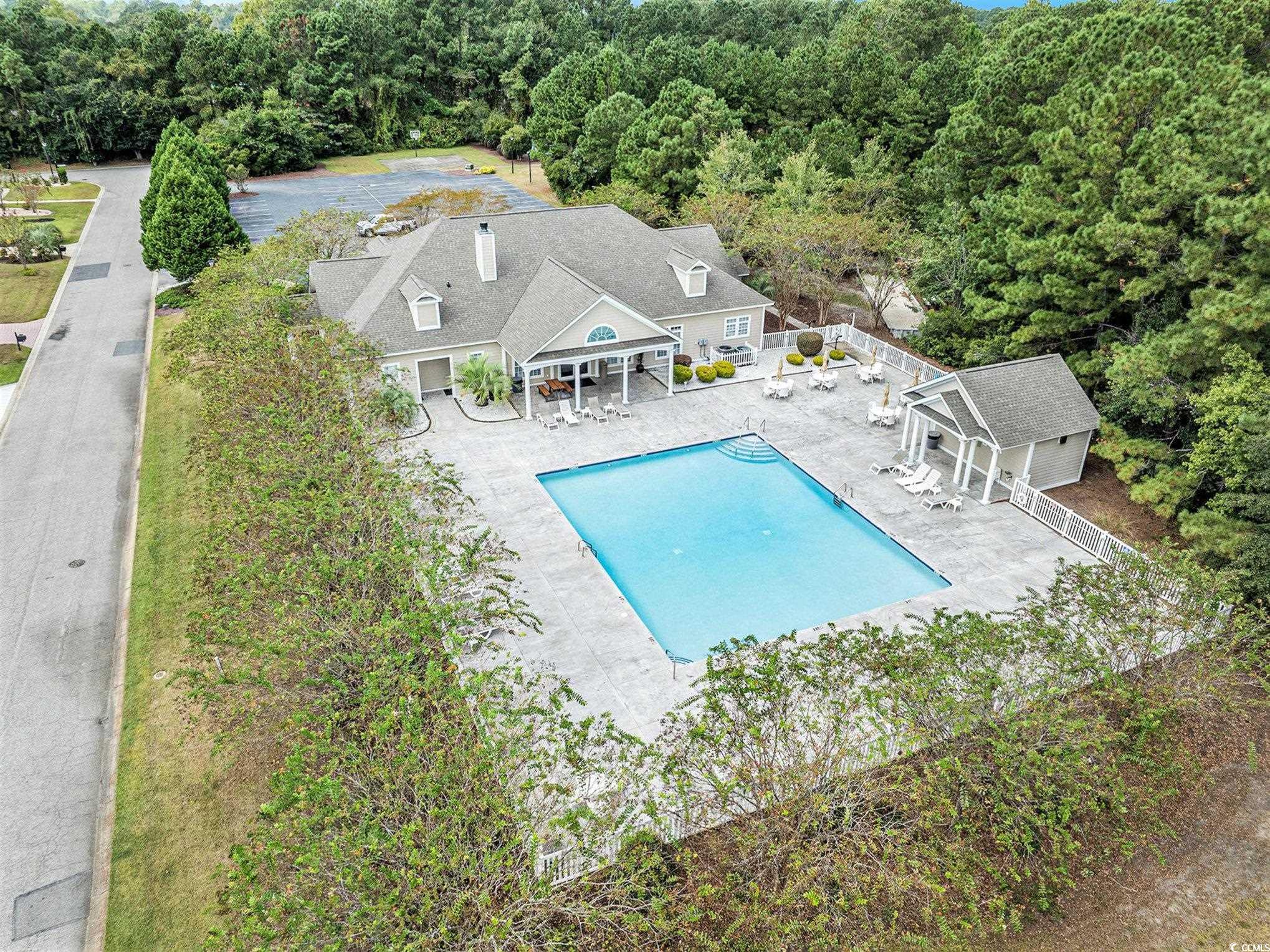 4036 Girvan Drive Myrtle Beach, SC 29579 - Photo 18 of 38 Community pool with a patio area and a wooded view