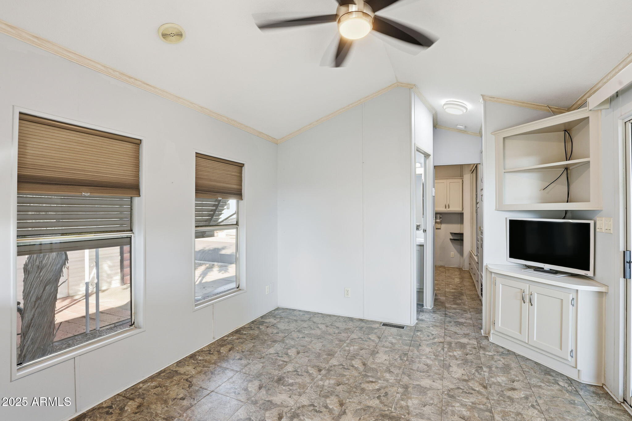 11201 North El Mirage Road, Unit 720 El Mirage, AZ 85335 - Photo 16 of 43 a view of a livingroom with a flat screen tv