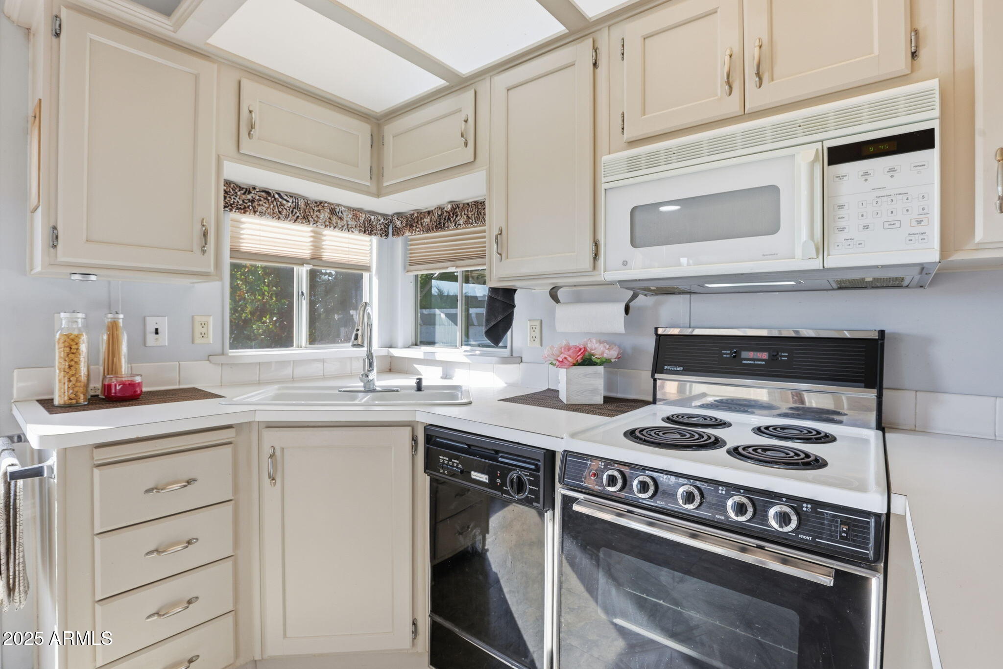 11201 North El Mirage Road, Unit 720 El Mirage, AZ 85335 - Photo 21 of 43 a kitchen with cabinets appliances a sink and a window
