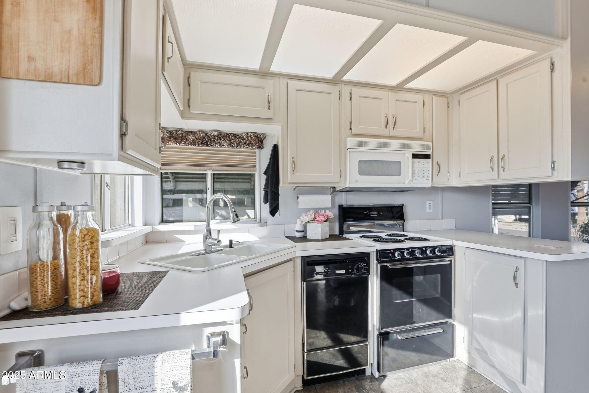 11201 North El Mirage Road, Unit 720 El Mirage, AZ 85335 - Photo 22 of 43 a kitchen with stainless steel appliances granite countertop a stove and cabinets