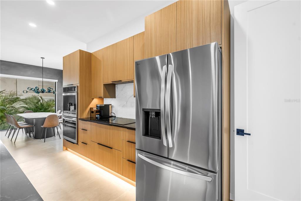 2305 Temple Street Sarasota, FL 34239 - Photo 13 of 64 a kitchen with stainless steel appliances a refrigerator and a stove