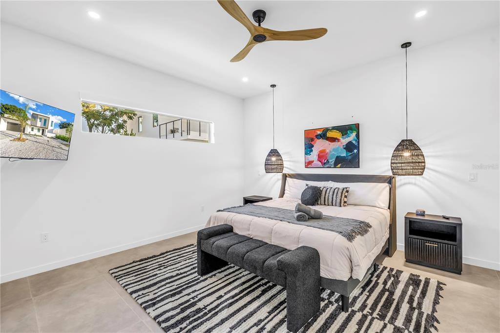 2305 Temple Street Sarasota, FL 34239 - Photo 20 of 64 a bedroom with a bed and a chandelier