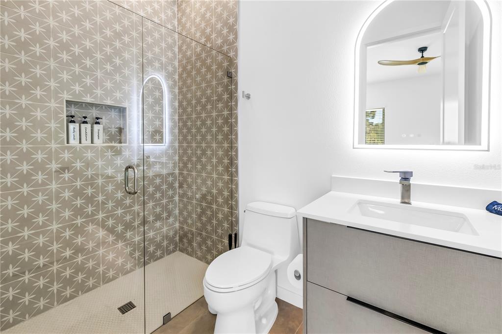 2305 Temple Street Sarasota, FL 34239 - Photo 32 of 64 a bathroom with a granite countertop sink toilet and shower