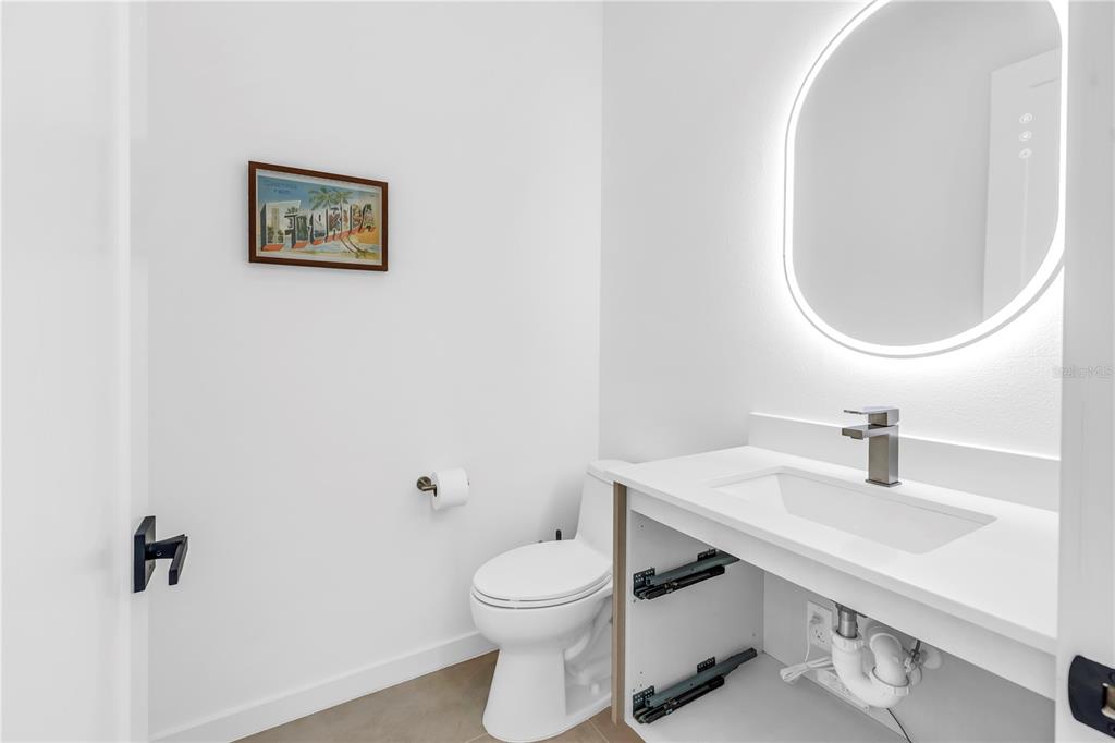 2305 Temple Street Sarasota, FL 34239 - Photo 33 of 64 a bathroom with a toilet a sink and mirror