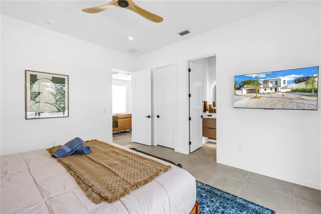 2305 Temple Street Sarasota, FL 34239 - Photo 43 of 64 a bedroom with a bed and a chandelier