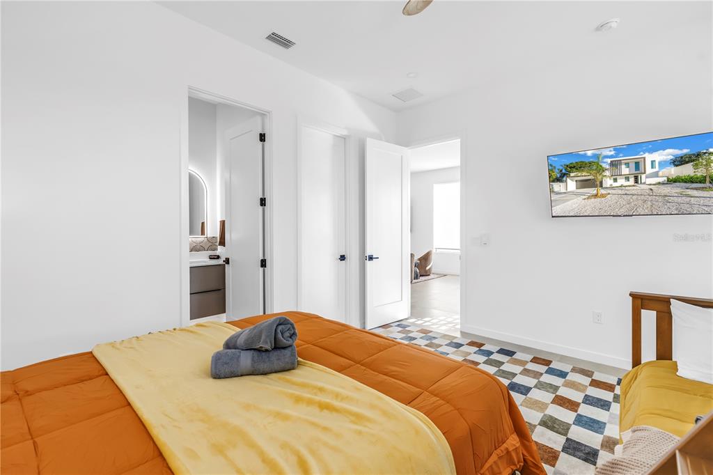 2305 Temple Street Sarasota, FL 34239 - Photo 46 of 64 a bedroom with a bed and wooden floor