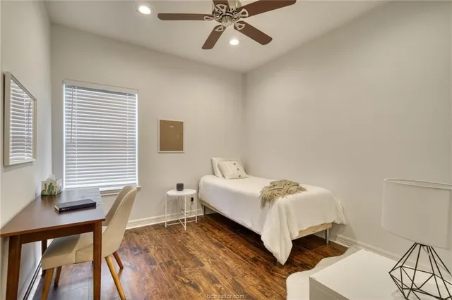 a bathroom with a granite countertop sink a toilet and a mirror