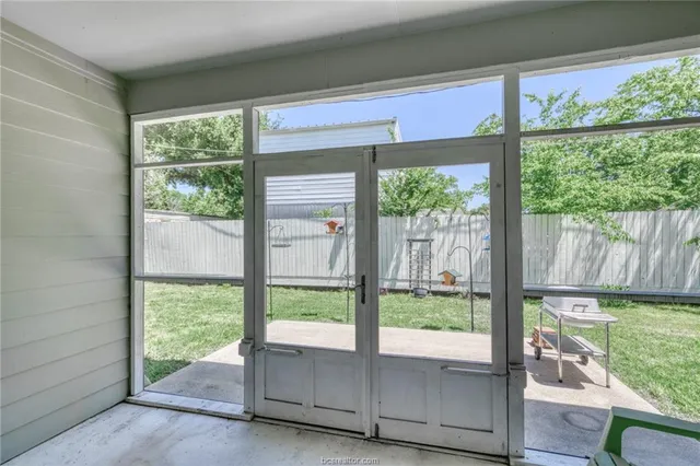 a living room with a bed furniture and a window