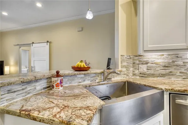 a kitchen with a sink and a stove top oven