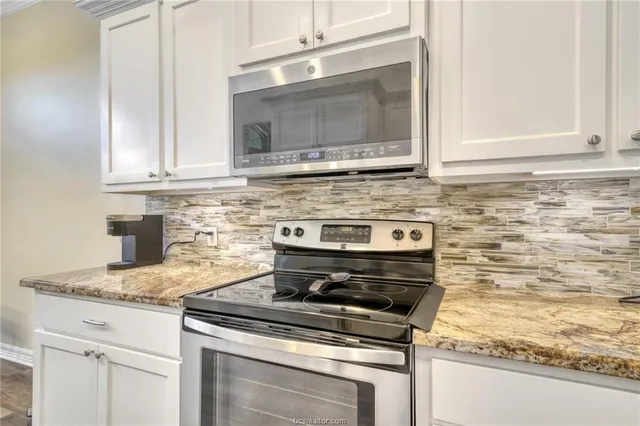 a stove top oven sitting inside of a kitchen