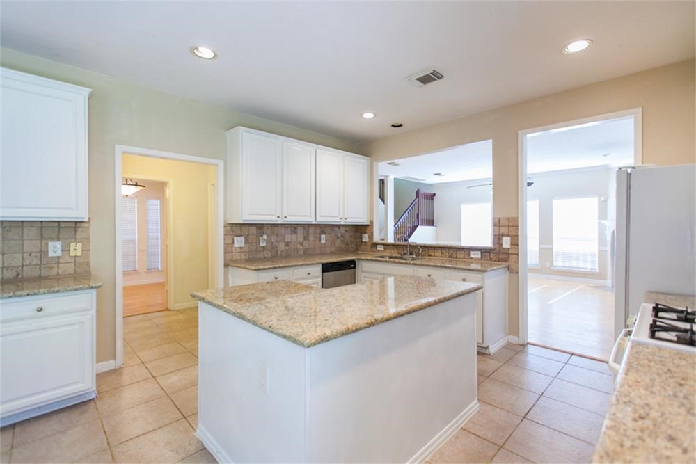 13630 Country Green Court Houston, TX 77059 - Photo 11 of 30 a kitchen with a sink refrigerator and cabinets