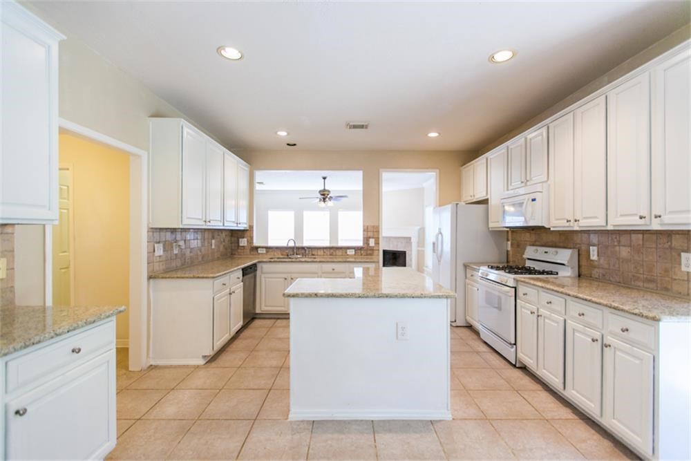 13630 Country Green Court Houston, TX 77059 - Photo 12 of 30 a large kitchen with stainless steel appliances granite countertop a stove a sink dishwasher and a refrigerator