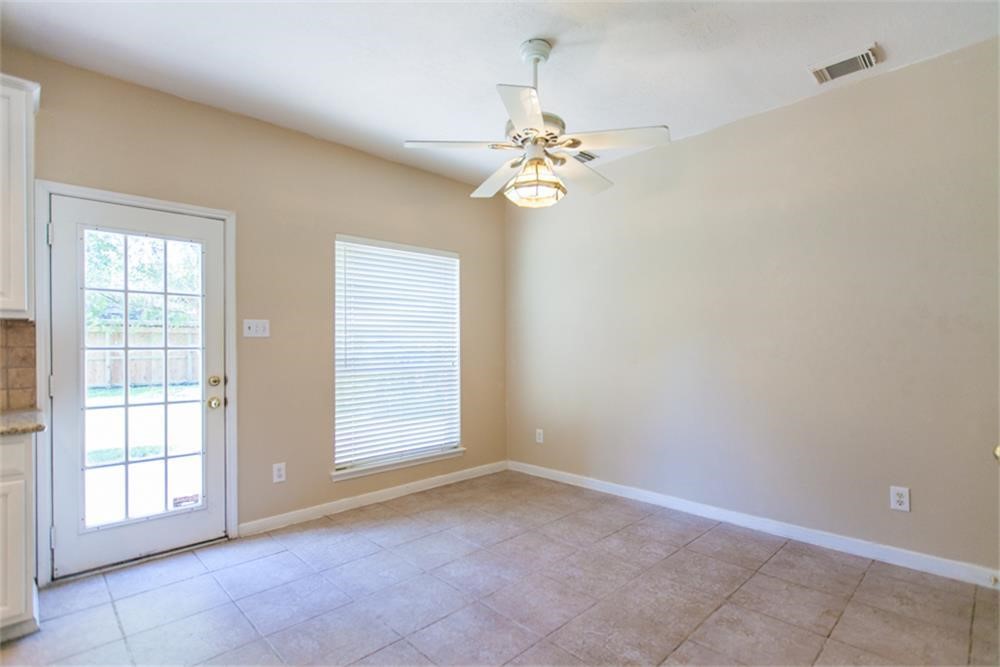 13630 Country Green Court Houston, TX 77059 - Photo 13 of 30 an empty room with windows and fan