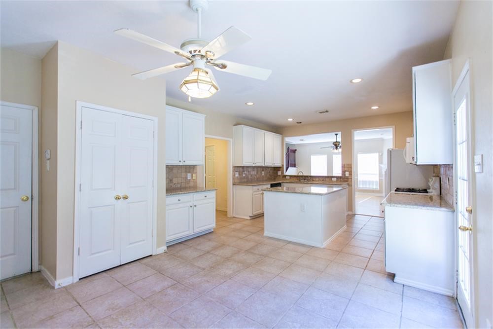 13630 Country Green Court Houston, TX 77059 - Photo 14 of 30 a large kitchen with a lot of counter space and stainless steel appliances