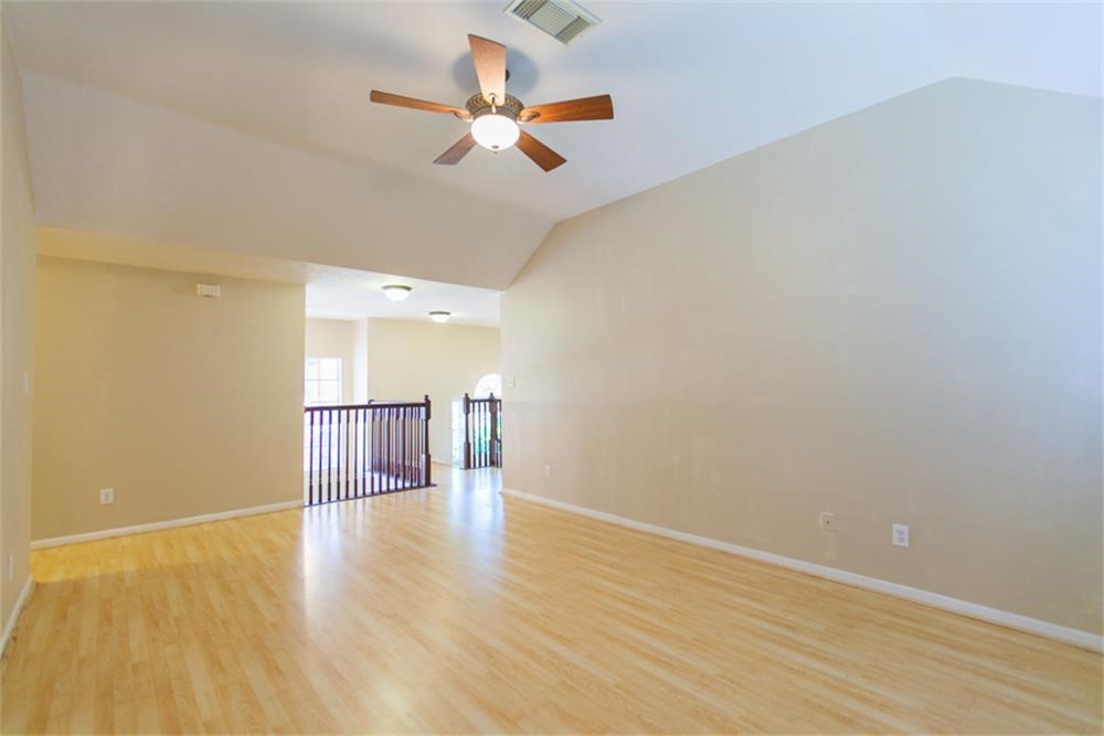 13630 Country Green Court Houston, TX 77059 - Photo 16 of 30 a view of a room with wooden floor and ceiling fan